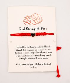 a red string bracelet with a heart on it and the words, red string of fate