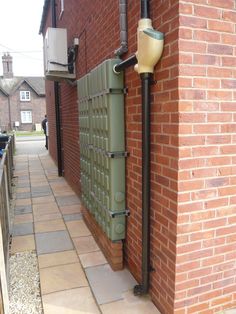 a brick building with a green door on it's side and a street light next to it