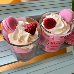 two cups filled with desserts sitting on top of a table