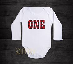 "Customize it to your colors! All colors available. 🛒Please leave your childs name in the notes at checkout. Family shirts are also available, just ask! This can be made in any of the listed sizes but also we can put it on a bodysuit or any other custom size or color, just send us a message and we will make it happen. CUSTOM ORDERS: If you want a size not listed please send us a message so we can set up a custom listing for you. SHIPPING AND TURNAROUND TIME: Our normal processing time is listed Custom Name White T-shirt For Birthday, Buffalo Plaid Party, Buffalo Plaid Birthday, Lumberjack First Birthday, Lumberjack Birthday, Plaid Party, Southern Baby, First Birthday Shirts, One Two Three