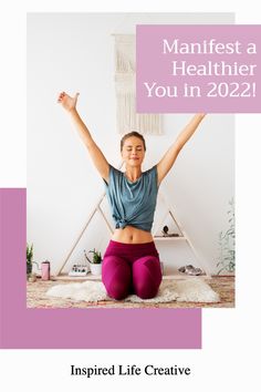 a woman sitting on the floor with her arms in the air