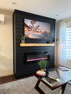 a living room with a fireplace and a painting on the wall