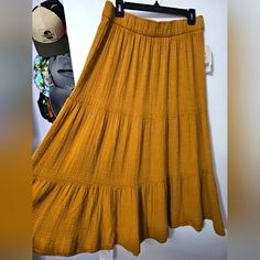 Bought To Wear Hippie-Style, But Style However. Crinkled Material, Lightweight. Elastic Waist. Mustard Color. This Skirt Still Has The Tags! Yellow Ruffled Long Skirt, Yellow Flowy Ruffled Maxi Skirt, Flowy Yellow Ruffled Maxi Skirt, Casual Yellow Tiered Maxi Skirt, Casual Mustard Skirt, Casual Yellow Maxi Skirt For Day Out, Yellow Tiered Skirt With Elastic Waistband, Casual Yellow Lined Maxi Skirt, Yellow Flowy Maxi Skirt For Day Out