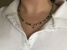 ✿ Mossy Green Trendy Necklace- cute little green glass beads, a dainty silver heart pendant and a silver closure (tarnish resistant!) ✿ 𝐀𝐛𝐨𝐮𝐭 𝐭𝐡𝐞 𝐏𝐫𝐨𝐜𝐞𝐬𝐬 I buy beads and wire from locally sources bead shops (including handmade glass beads) and then design and string all the necklaces. 𝐒𝐢𝐳𝐢𝐧𝐠 The sizes I offer currently are 16inch to 20 inch, however, I offer extended sizing to those who would prefer it; just place that information in the custom tab or send me a message :) In Aesthetic Necklace, Mossy Green, Trendy Necklace, Trendy Aesthetic, Buy Bead, Handmade Glass Beads, Silver Heart Pendant, Bib Necklaces, Trendy Necklaces