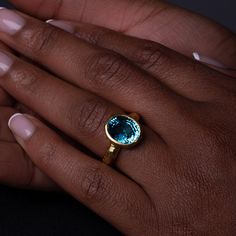 One-of-a-kind, hand-crafted ring centering 10.20 carat oval shape, fine gem quality vivid color Blue Zircon set in 18karat yellow gold bezel and 22karat yellow gold hammered setting. Size 7, can be sized upon request. Zircon might be one of the most under-appreciated colored gemstones and please do not confuse it with cubic zirconia, or CZ, an artificial product from the mid-1970s. Zircon found in Australia is the oldest mineral on earth: 4.4 billion years old. In the Middle Ages, this gem was t Gold Oval Topaz Ring With Bezel Setting, Gold Oval Cabochon Topaz Ring, Gold Oval Cabochon Topaz Ring Gift, Gold Topaz Oval Cabochon Ring As Gift, Oval Yellow Gold Topaz Ring With Bezel Setting, Handmade Gold Topaz Ring With Oval Shape, Handmade Gold Topaz Ring In Oval Shape, 3d Printed Necklace, 3d Printed Earrings