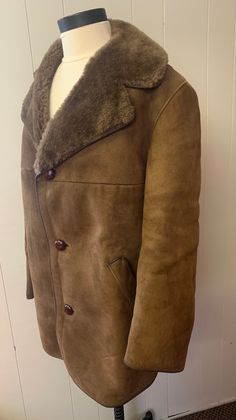 "Gorgeous unisex vintage 1970s sheepskin coat. Fabulous condition. Cozy an warm and will last at least another 20 years! Measurements are: Length of coat front 36 1/2\" Armpit to Armpit: 22\" Width at bottom from front: 24 1/2\" Sleeve Length: 24\" 2 Pockets Length of coat from the back to the bottom 32 1/2\" long  Tag reads 108/42 1/2\". Some very minor wear on collar. More measurements available if needed. Shipping is an estimate only and overages are promptly refunded." Vintage Pea Coat For Winter, Vintage Brown Pea Coat For Winter, Retro Mink Outerwear For Winter, Retro Mink Colored Winter Outerwear, Vintage Leather Outerwear For Cold Weather, Vintage Brown Winter Pea Coat, Vintage Long Brown Pea Coat, Classic Sheepskin Long Sleeve Outerwear, Vintage Brown Long Pea Coat