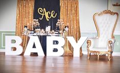 a baby shower is set up with gold sequins and white chairs for the guests to sit in