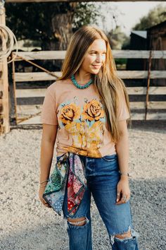 Saddle up in style with our Boots & Roses Tee! Made from soft 100% cotton fabric, this western tshirt features a playful cowboy boots and roses graphic, perfect for any cowgirl. The coral mineral wash adds a unique touch to this short sleeve tee. Haylee is wearing size small paired with The Carter Jeans, the Coyote Knox Sandals and Vintage Feedsack Wild Rag Country Style T-shirt For Rodeo In Spring, Western Style T-shirt For Country Concerts In Spring, Country Style T-shirt For Spring Events, Spring Country Style T-shirt For Country Events, Casual Spring T-shirt For Country Events, Country Style Short Sleeve T-shirt For Spring, Western Tshirt, Roses Graphic, The Carter