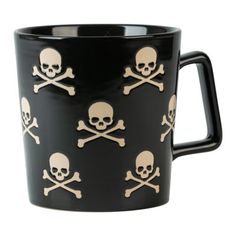 a black mug with skulls and bones on it