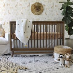 a baby crib with two stuffed animals next to it