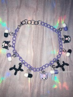 This fun charm bracelet features a purple chain with cute purple characters as well as black balloon dogs and purple and black pill charms. This simple lightweight piece is pastel goth meets Y2K in the best way! Cute Purple Charm Bracelet For Friendship, Cute Purple Hypoallergenic Bracelets, Purple Y2k Bracelet, Spiritual Purple Jewelry With Charms, Adjustable Purple Metal Charm Bracelet, Spiritual Purple Beaded Charm Bracelet, Adjustable Purple Bangle Charm Bracelet, Purple Y2k, Black Balloons