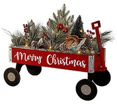 a red wagon filled with pine cones and christmas decorations