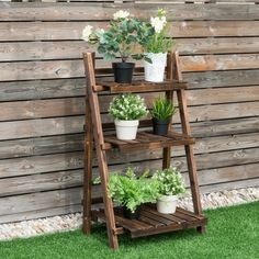 three tiered wooden plant stand with potted plants