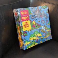 a children's book about the happy isles sits on a black leather chair in a room