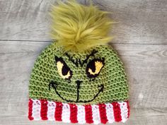 a crocheted green cat hat with yellow hair