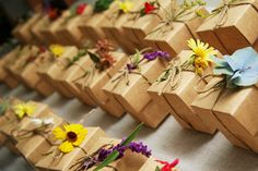 several small boxes with flowers tied to them