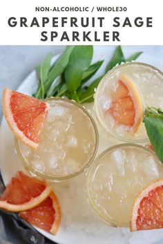 three glasses filled with ice and grapefruit on top of a white plate