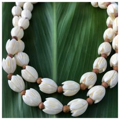 "This necklace is made with 12x10mm (large) ivory colored lucite vintage pīkake beads and accented with 4mm ʻiliahi (sandalwood) beads. Necklace length measures approximately 30\"." White Jewelry With Oval Wooden Beads, Traditional Cream Necklace As A Gift, Traditional Cream Necklace For Gift, Traditional White Single Strand Beaded Necklace, White Spiritual Jewelry With Wooden Beads, Spiritual White Jewelry With Wooden Beads, Vintage White Hand-strung Necklaces, White Wooden Beads Jewelry For Meditation, White Wooden Beads Necklace For Meditation