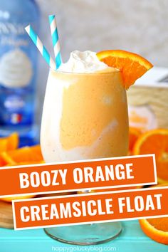 boozy orange creamsice float in a glass with two straws