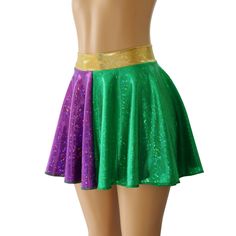 "Green and Purple Holographic Spandex Circle Skirt with a 2\" Hologram Wasitband. You are sure to be sparking at your next event in this sassy little skirt! WAISTBAND OPTIONS 1. GREEN HOLOGRAM 2. PURPLE HOLOGRAM 3. GOLD HOLOGRAM SKIRT LENGTHS Skirt Lengths: Front/Back Toddler 2/37\"/8\" Child X-Small 10\" / 11\" Child Small12\"/13\" Child 6X-711\"/12\" Child Medium13\"/14\" Child Large13\"/14\" Adult XS 13\"/14\" Adult Small 14.5\" / 16\" Adult Medium14.5\"/16\" Adult Large15\"/17\" Adult X-Larg Fitted Party Skort With Elastic Waistband, Fitted Green Skirt With Elastic Waistband, Stretch Skirt For Cheerleading, Fitted Party Skirt With Elastic Waistband, Fitted Skirt With Elastic Waistband For Party, Stretch Purple Bottoms For Costume Party, Purple Stretch Bottoms For Cheerleading, Stretch Lined Mini Skirt For Cheerleading, Party Skirt With Wide Stretch Waistband