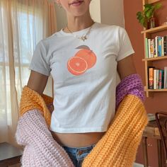 Brighten up your wardrobe with our orange baby tee! 🍊 This vintage fruit shirt is perfect for your farmers market or summer harvest. Embrace 2000s fashion with this vintage-style graphic crop top, adding a fresh and playful touch to your collection. Click now to add it to your cart and enjoy the zest of summer! 🫧 SIZING * Available sizes: XS -XL * This garment is true to size, but size down if you prefer a more fitted look. * Keep in mind, this garment is in youth sizing to achieve the baby te Milkmaid Aesthetic, Fruit Shirt, Summer Harvest, Shirt Y2k, Graphic Crop Top, Graphic Tee Outfits, Vintage Fruit, Orange Baby, Y2k Baby Tee