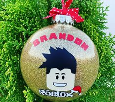 a christmas ornament with a cartoon character on it's face and name