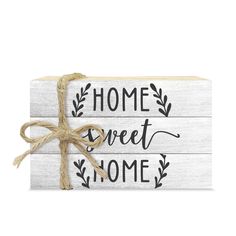 a wooden sign that says home sweet home with a bow on the front and back