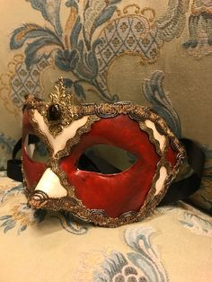 "Traditional and original papier-mache Venetian mask, handmade and decorated with acrylics colors, gold-leaf and trimming. This traditional Venetian mask shape is called \"Colombina\". All our masks are handmade papier-machè masks made in Venice. Our decorators use techniques typical of the Venetian tradition such as stucco, acrylics, gold and silver-leaf, macramè, passementerie, pearls and crequelè to give you a wide range of masks. This shape is available in many different designs, colors and Vintage Eye Mask For Costume Party, Venetian Multicolor Masquerade Mask, Venetian Mask For Mardi Gras Costume, Artistic Red Masquerade Mask, Artistic Red Masks For Costume Party, Artistic Red Mask For Costume Party, Vintage Eye Mask For Mardi Gras, Artistic Red Mask For Costume, Artistic Red Masks And Prosthetics For Costume Party