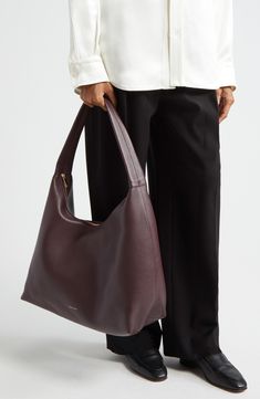 Slouchy and spacious, this oversized hobo bag is made in Italy from soft, grained leather with a supple suede lining and simple shoulder strap. Top zip closure Shoulder strap Calfskin-suede lining Leather Made in Italy Designer Handbags Nothing Written Bag, Designer Hobo Bags, Slouchy Shoulder Bag, Slouchy Leather Bag, Sew Handbag, Slouchy Bags, Baggy Bag, Designer Work Bag, Practical Outfits