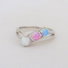 Vintage Sterling Silver White, Blue, Pink Opal Three stone Ring ...Marked 925...Total of weights 2.7grams...Size 7...Measure of Face 6.5MM...It's in very good condition. A#01 791 Sterling Silver Multi-stone Opal Promise Ring, Opal Multi-stone Promise Ring, Opal Multi-stone Rings For Promise, Adjustable Multi-stone Opal Ring For Anniversary, Sterling Silver Opal Ring With Accent Stones, Silver Three Stone Opal Ring, Blue Opal Birthstone Ring In Sterling Silver, Multicolor Opal Multi-stone Rings, Adjustable Multi-stone Blue Rings