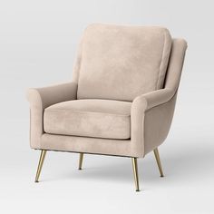 an olive green chair with gold legs