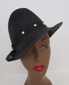 "Vintage 1950s black faux straw trilby hat.  From Juli Kay Chicago with union label. Cocky exaggerated shape with tall creased crown and asymmetrical narrow brim. Wide grosgrain band with gold stud detail.  I will leave the hat pin previous owner attached to back.  Vintage and preowned fashion is a simple sustainable way you can reuse recycle repurpose for a healthier Earth, Condition:   Very good vintage condition, slightest misshape, wear inside band, See photos. Size:  Sits up high on head. M Retro Formal Fedora With Wide Brim, Retro Adjustable Fedora For Formal Occasions, Retro Wide Brim Fedora For Formal Occasions, Adjustable Retro Fedora For Formal Occasions, Retro Fedora Hat For Formal Occasions, Retro Fedora With Short Brim For Formal Events, Retro Fedora With Short Brim For Formal Occasions, Retro Short Brim Fedora For Formal Events, Retro Short Brim Fedora For Formal Occasions