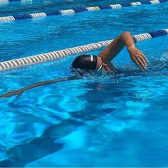 a woman swimming in a pool with her head above the water