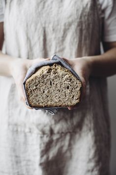 a person holding a loaf of bread in their hands