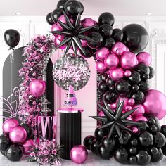 black and pink balloons are in the shape of a christmas tree