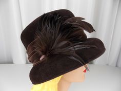 "Vintage cloche style hat in brown felted wool embellished with wide velveteen hatband and feathers. Very good vintage condition. Label: Laura Ashley Crown height 4 1/2\" Inside brim 22\" We have many hats listed in our store. Check them out here: https://www.etsy.com/shop/ofcorsetsvintage?section_id=14391072&ref=shopsection_leftnav_7 But why just limit yourself to one? We offer discount shipping when purchasing multiple items and international shipping. Please email me for a quote." Formal Brown Top Hat For Fall, Winter Felt Hat With Feathers And Short Brim, Winter Feathered Brimmed Felt Hat, Brown Felt Hat With Feathers And Curved Brim, Vintage Brown Top Hat For Fall, Brown Fur Felt Top Hat For Winter, Brown Hats With Feather Trim And Curved Brim, Brown Curved Brim Hat With Feather Trim, Vintage Brown Felt Hat For Winter