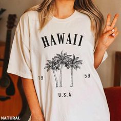 This Hawaii palm tree shirt is super soft and cozy. Perfect to lounge around, run errands, or walk your dog. ABOUT THIS SHIRT   ∙ Shirt is UNISEX and runs slightly large for ladies (For a relaxed fit, I suggest your usual size. For an oversized fit, I suggest sizing up 1 to 2 sizes.) ∙ Solid Colors: 100% airlume ringspun cotton, Dark Grey Heather: 52% cotton, 48% polyester, Athletic Heather 90% cotton, 10% polyester ∙ Colors may vary based on your monitor/screen display or lighting CARE INSTRUCT Hawaii Clothing, Hawaii Crewneck, Palm Tree Shirt, Hawaii Outfits, Hoodie Cute, Vintage Hawaii, Tree Shirt, Hawaii Shirt, Oahu