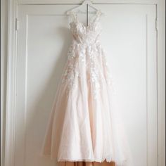 a dress hanging up on a door