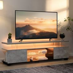 a flat screen tv sitting on top of a entertainment center