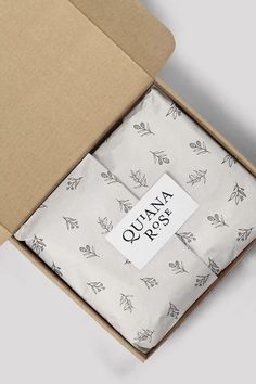 an open box with a piece of cloth in it that says quiana o'clock