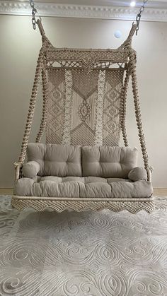 a white swing bed with pillows on it in a room that has carpeted flooring