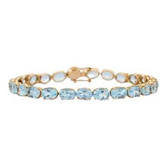 This is part of Chairish’s Fine Jewelry assortment.  This Sparkling Blue Topaz Tennis Bracelet in 18K gold showcases 25 endlessly sparkling natural blue topaz, weighing 28.5 carats. It measures 7.5 inches long in length.  Blue topaz helps to improve communication and self expression.  Designed with perfect oval cut blue topaz set in solid gold basket settings in repetition making a beautiful bracelet to make you stand out on any occasion or event. The elegant style complements the attire beautifully and this is a perfect Unique Gift, Bridal Shower Gift, Secret Santa Gift, Gift For Sister, Mother Daughter Gift, Bride To Be Gift, Bridesmaid Gift, Thanksgiving Gift, Anniversary Present, Christmas Gift or any Holiday Gift for Mother, Sister, Daughter, Grandma, Fiancé, Girlfriend, Valentine, Fa Fine Jewelry Blue Topaz Bracelets, Luxury Blue Bracelets With Gemstone Accents, Luxury Blue Gemstone Tennis Bracelet, Luxury Blue Topaz Gemstone Bracelets, Luxury Blue Topaz Bracelets For Formal Occasions, Luxury Blue Topaz Bracelets, Blue Topaz Oval Bracelets, Elegant Gold Aquamarine Bracelet, Luxury Light Blue Topaz Jewelry