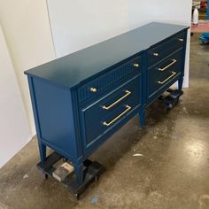 a blue dresser sitting on top of a hard wood floor