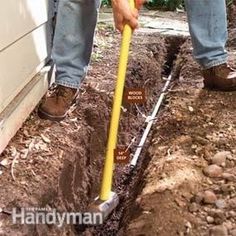 a man is digging in the ground with a shovel