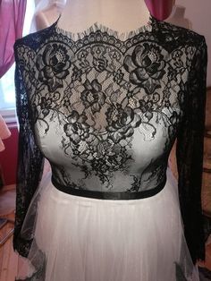 a white dress with black lace on it