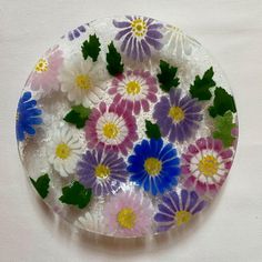 a glass plate with flowers painted on it