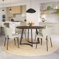 a round table with four chairs around it in a modern style kitchen and dining room