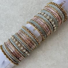 Large stack of antique Gold bangles with pink and pale blue shades.  Ready to Ship! Festive Pink Stackable Bracelets, Bangle Stack, Wedding Jewelry Sets Bridal Jewellery, Thread Bangles Design, Indian Bridal Jewelry Sets, Pretty Jewelry Necklaces, Fancy Jewellery Designs, Bangles Jewelry Designs, Bridal Bangles