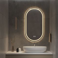 a bathroom with a sink, mirror and lights on the wall above it's counter