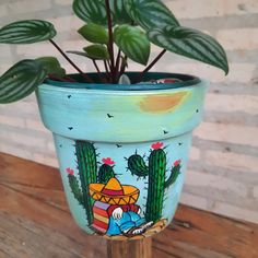 a potted plant sitting on top of a wooden table